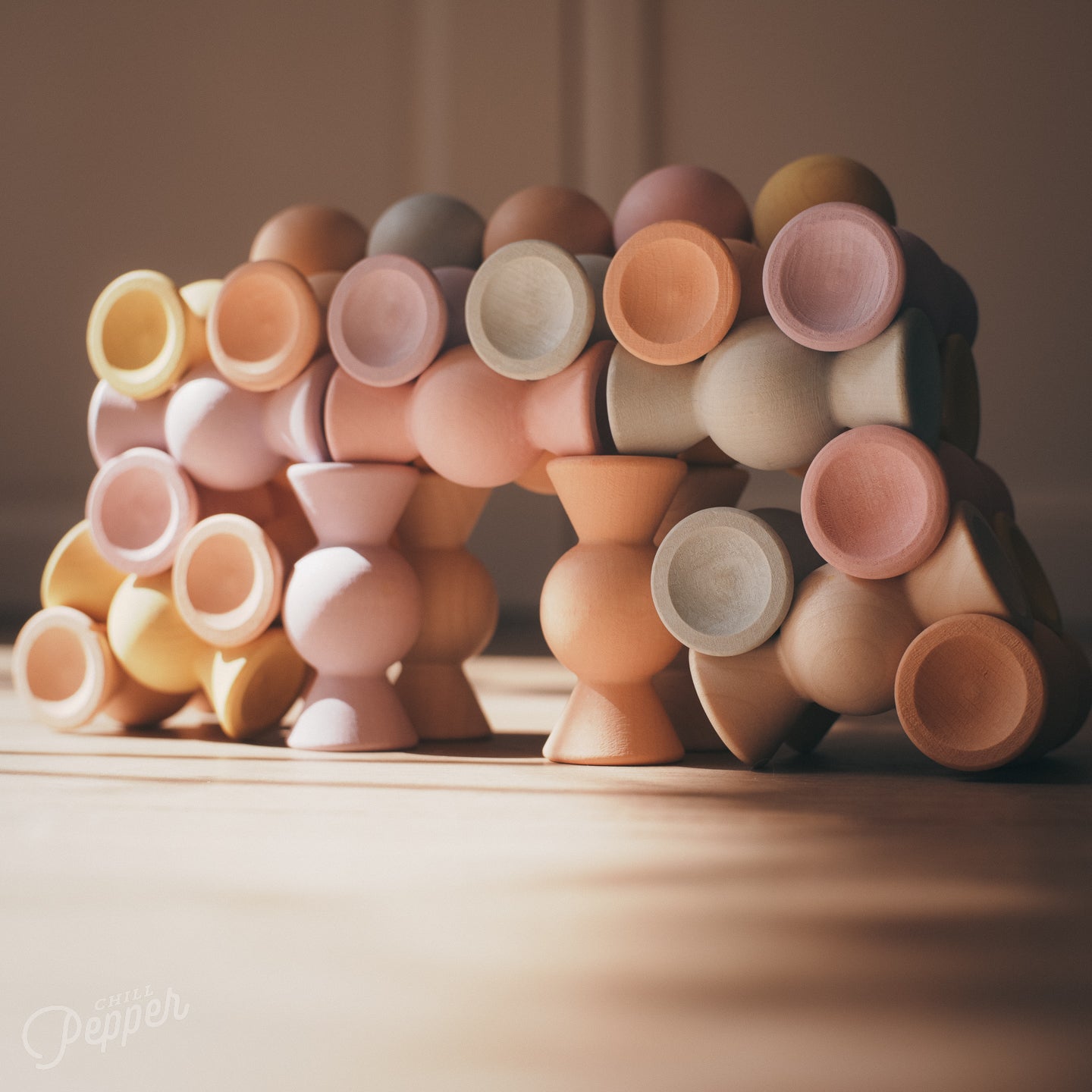 Chill Pepper Sweets wooden stacking game - An intricate bridge built using all geometric options of the pieces. Versatility to the max