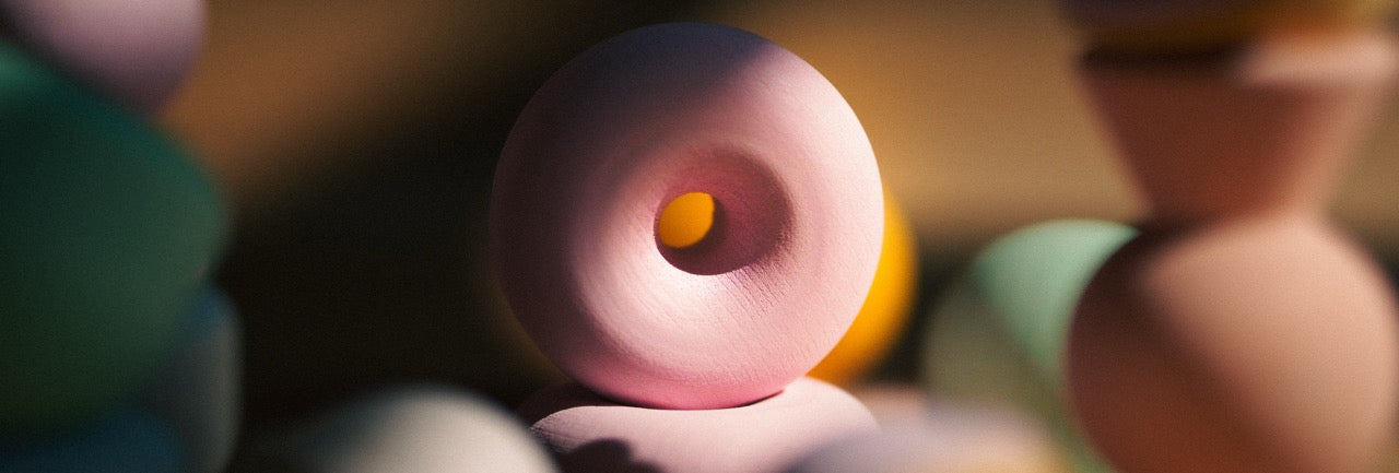 Chill Pepper Treats - a close-up of the wooden donut in the set. This set is great as a stacking game, but each of the pieces are also great spinning tops. This results in these wooden toys being super open ended for creative building, playing, stacking and mandalas