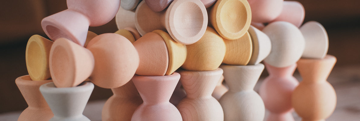 Chill Pepper Sweets, the ultimate wooden stacking game has various way to stack and play with them. Here combined in a tower show close-up to show the matte pastel colors and the grain of the European sustainable wood
