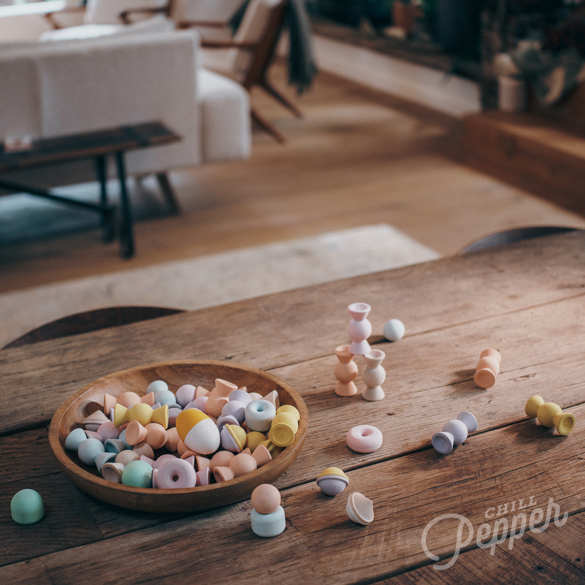 Chill Pepper Sweets wooden stacking game - Loose parts play on a table together with the Chill Pepper Treats stacking and spinning game